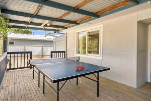 a ping pong table on the deck of a house at Pet Friendly Island Garden Retreat in Cowes in Cowes