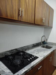a kitchen with a stove and a sink at Bungalows Anton in San Blas