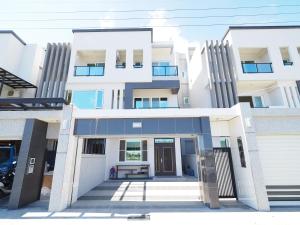 a white house with the front entrance to it at Love and Peace B&B in Taitung City