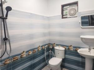a bathroom with a toilet and a sink at Minsara Villa in Ahangama +14 photos