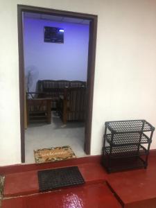 a door to a room with two chairs and a table at Minsara Villa in Ahangama