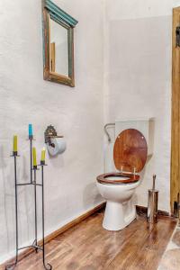 ein Badezimmer mit einem WC und einem Holzsitz in der Unterkunft Dominic Boutique in Sighişoara