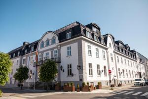 a large white building on the side of a street at Home Hotel Atlantic in Sandefjord