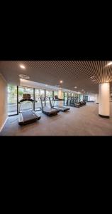 a gym with a row of treadmills and machines at Cozy 1 bed and 1bath suit in Surrey