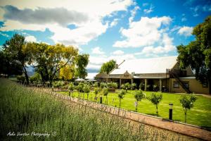 una casa con un jardín delante de ella en Surval Boutique Olive Estate, en Oudtshoorn