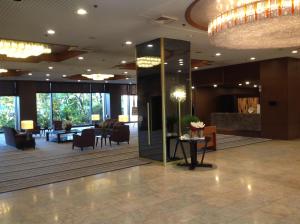 a lobby of a hotel with chairs and a table at Okayama Plaza Hotel in Okayama