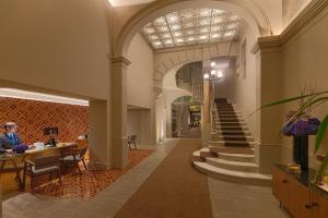 
a large staircase leading up to a large room at H10 Casa Mimosa 4* Sup in Barcelona
