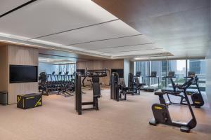 a gym with tread machines and a flat screen tv at Hyatt Regency Xi'An Chanba in Xi'an