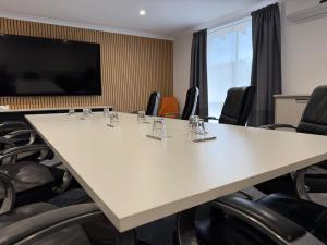 a conference room with a large table and chairs at Busselton Motel in Busselton