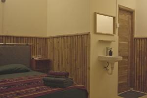 a hotel room with a bed and a sink at Kokomo Yogyakarta in Yogyakarta