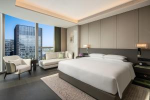 a bedroom with a large white bed and a large window at Hyatt Regency Xi'An Chanba in Xi'an +60 photos