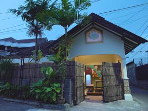a small house with a tree in front of it at Kokomo Yogyakarta in Yogyakarta