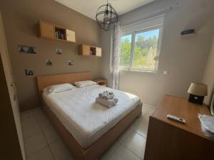 a bedroom with a bed with a teddy bear on it at Casa Fountain Villa in Kolymbia +9 photos