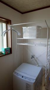 a white shelf in a room with a washing machine at 空海の宿平生 in Saga +38 photos