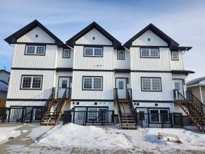 a large white house with black roof at Harmony Haven in Drumheller in Drumheller