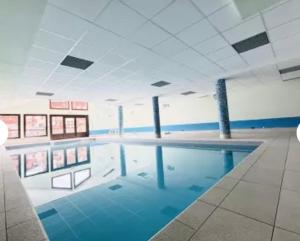 a large swimming pool in a large building at Chalet des Evettes in Flumet