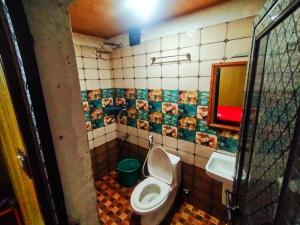 a bathroom with a toilet and a sink at Munnar Plantation Villa in Munnar +77 photos