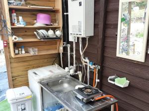 a kitchen with a sink in a tiny house at Beetopia in Minamioguni