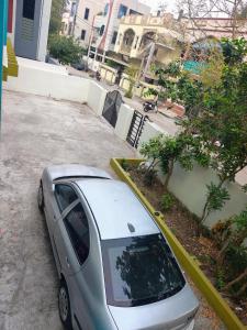 a small silver car parked in a parking lot at Elixir Mansion in Pālakollu