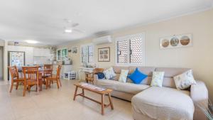 a living room with a couch and a table at Driftwood At Beachmere in Beachmere