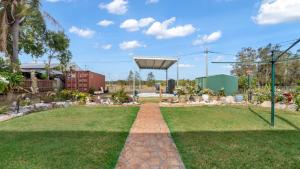 a garden with a basketball hoop in a park at Driftwood At Beachmere in Beachmere