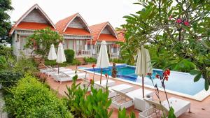 a resort with a pool and chairs and umbrellas at Darya Sea View by ABM in Nusa Penida +110 photos