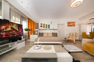 a bedroom with a bed and a tv and a couch at AP Silvija in Zadar