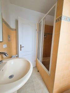 a bathroom with a white tub and a shower at Nordlandgiebel in Rosengarten +25 photos