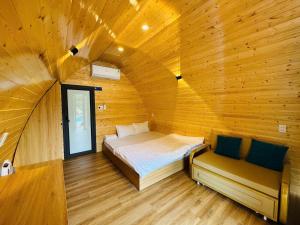 a bedroom with a bed in a wooden cabin at Bình An Mountain Side Bungalow in Nguyên Ngoại +31 photos