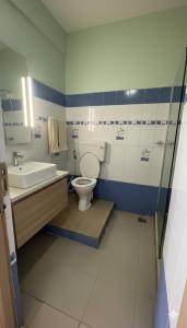 a bathroom with a toilet and a sink at Anand Comfort in Anakāpalle