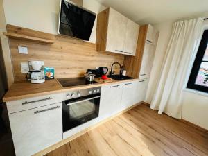 a small kitchen with a sink and a stove at Ferienwohnung Alpen Auszeit in Rieden