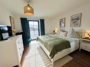 a bedroom with a bed and a tv and a window at Ferienwohnung Alpen Auszeit in Rieden +20 photos