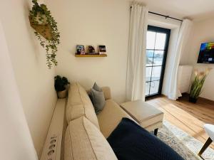 a living room with a couch and a window at Ferienwohnung Alpen Auszeit in Rieden