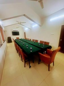 a conference room with a long green table and chairs at Ocean White Sands Resort & Spa in Varca