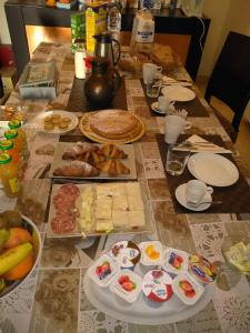 a table with food and plates of food on it at Villa Magnolia B&B in Taormina