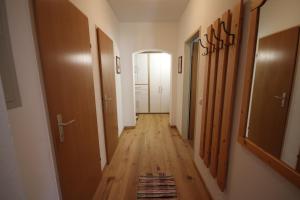 a hallway with wooden floors and a hallway with doors at Appartement Alpenblick by Schladming-Appartements in Schladming
