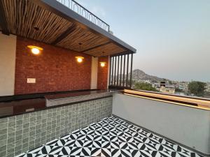 a balcony with a black and white tile floor at Hotel Annant Jawai in Sheoganj