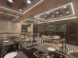 a restaurant with tables and chairs in a room at Hotel Annant Jawai in Sheoganj