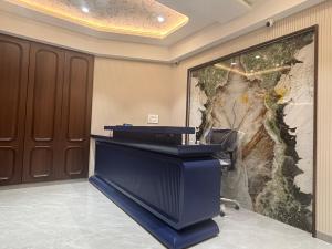 a desk in a room with a large painting on the wall at Hotel Annant Jawai in Sheoganj