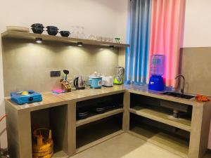 a kitchen with a counter top with a counter top at The Ondoro in Kamburugamuwa