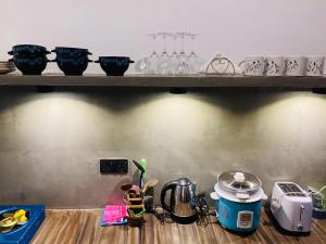 a shelf with glasses and other items on it at The Ondoro in Kamburugamuwa