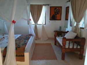 a bedroom with two beds and a window at Shira house in Watamu +44 photos