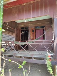an outside view of a house with an open door at Kulapkaow in Don Det