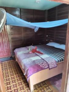 a bedroom with a bunk bed with a mosquito net at Kulapkaow in Don Det