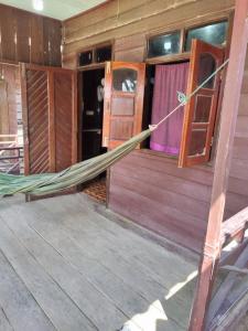 a hammock in the inside of a house at Kulapkaow in Don Det