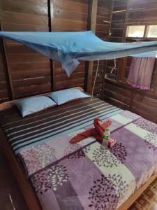 a bed with a mosquito net on top of it at Kulapkaow in Don Det