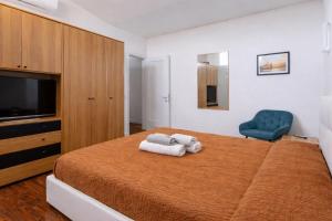 a bedroom with a large bed and a blue chair at I profumi del centro in Prato