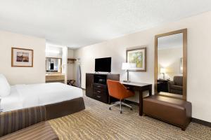 a hotel room with a bed and a desk with a computer at Quality Inn Mount Vernon in Mount Vernon