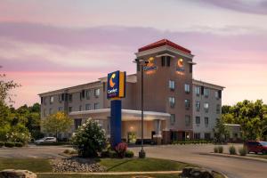 a hotel with a sign in front of a building at Comfort Suites Elizabethtown in Elizabethtown