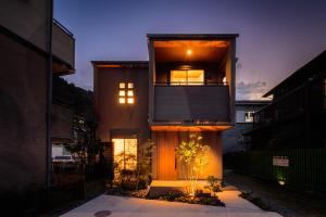 a house with a balcony on the side of it at TEMARI Premier NORTH in Hakone